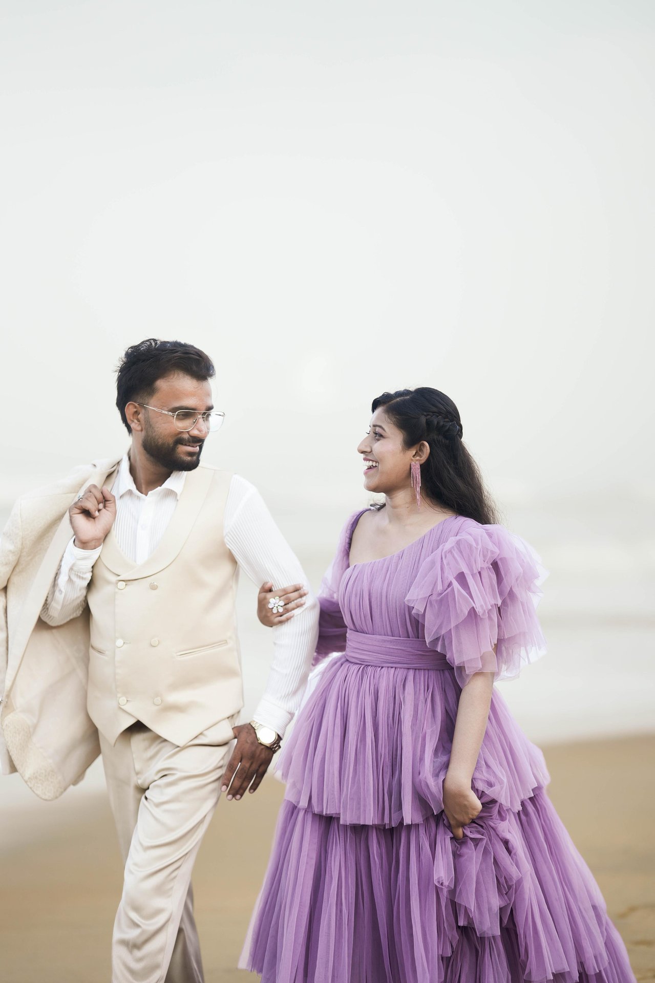 Purushotham and Nikitha walking together by the sea